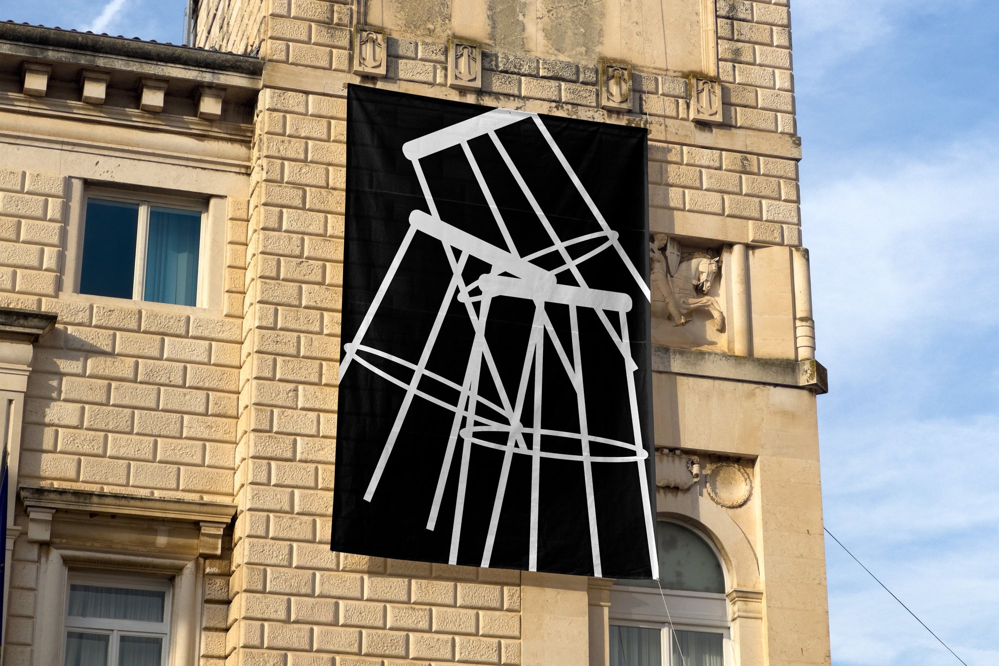 Aedes exterior banner — abstract chair line-art on the exhibition building